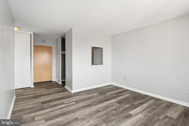 spare room with wood-type flooring