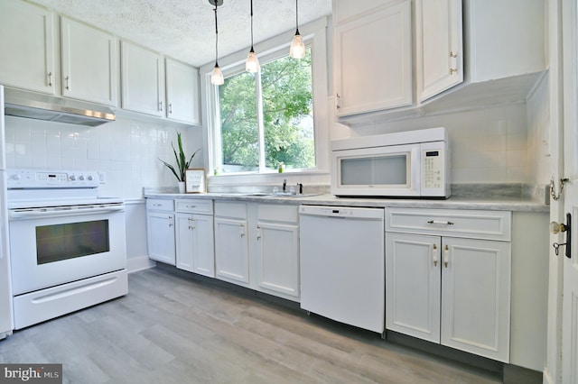 kitchen with tasteful backsplash, light hardwood / wood-style flooring, hanging light fixtures, white appliances, and white cabinets