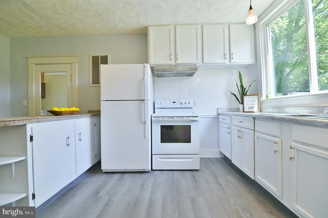 kitchen featuring hanging light fixtures, white cabinets, white appliances, and light hardwood / wood-style flooring