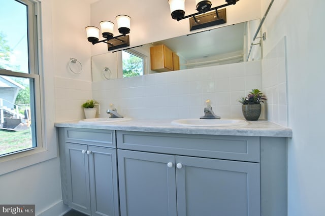 bathroom featuring vanity and backsplash