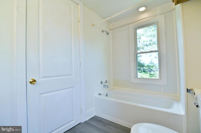 bathroom with wood-type flooring and shower / washtub combination