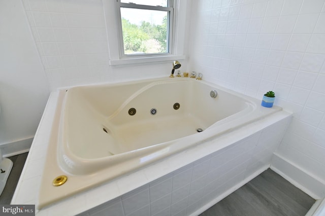 bathroom featuring tiled tub