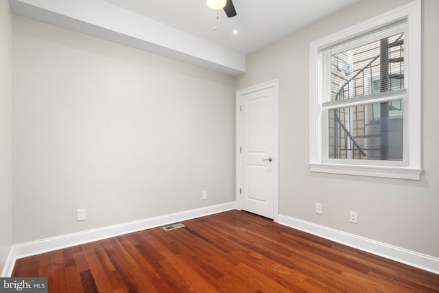 empty room with ceiling fan and hardwood / wood-style flooring