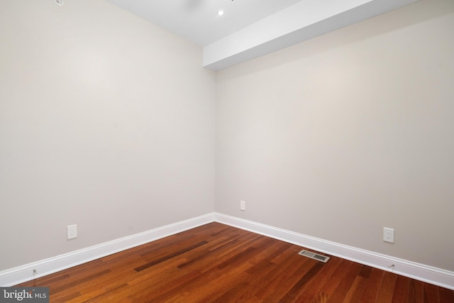 empty room featuring recessed lighting, visible vents, baseboards, and wood finished floors