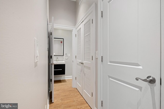 hall featuring sink and light hardwood / wood-style floors