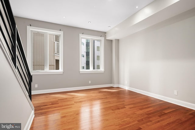 spare room with light wood-style floors and baseboards