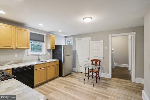 kitchen with sink, dishwasher, light wood-type flooring, and stainless steel refrigerator