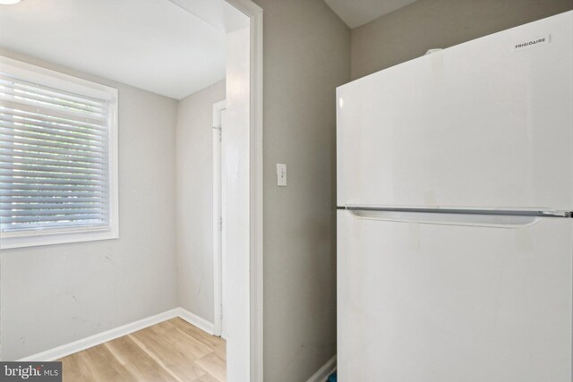 interior space with light hardwood / wood-style floors and white refrigerator