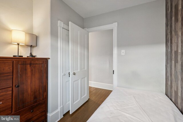 bedroom featuring dark hardwood / wood-style floors and a closet