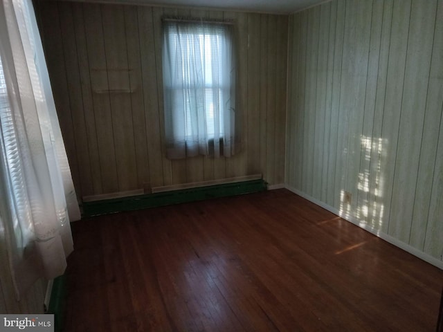 unfurnished room with hardwood / wood-style flooring