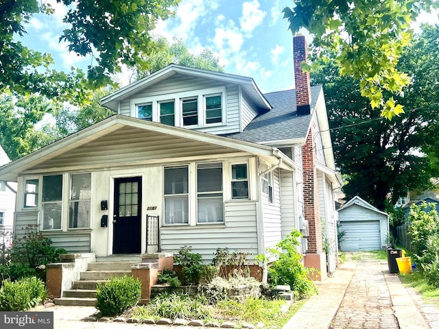 view of front facade featuring an outdoor structure and a garage