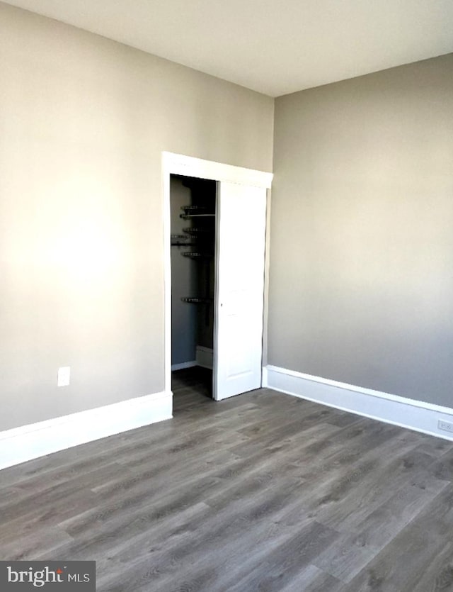 unfurnished bedroom with hardwood / wood-style floors and a closet