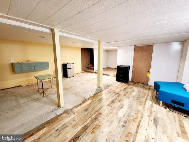 basement with stainless steel refrigerator