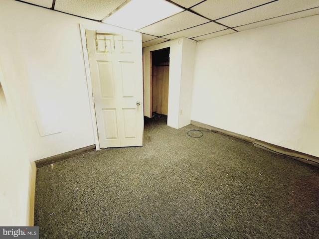 basement with carpet floors and a paneled ceiling