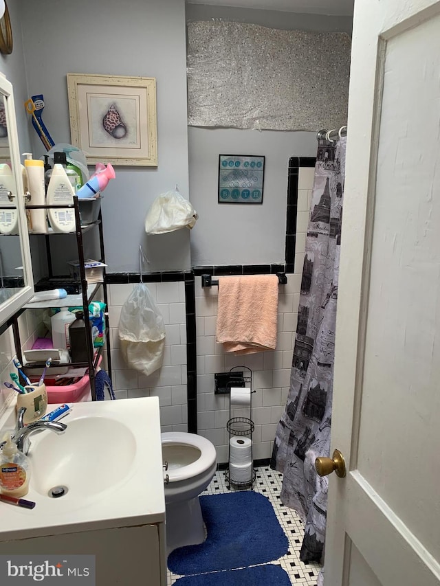 bathroom featuring tile walls, tile patterned flooring, vanity, and toilet