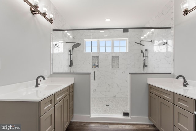 bathroom with hardwood / wood-style flooring, vanity, and an enclosed shower