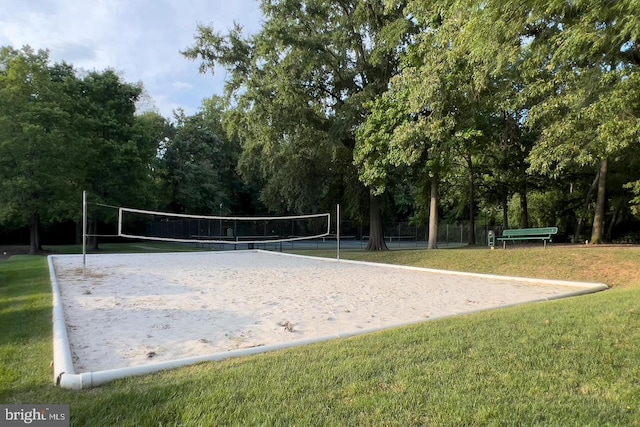 view of home's community with a lawn and volleyball court