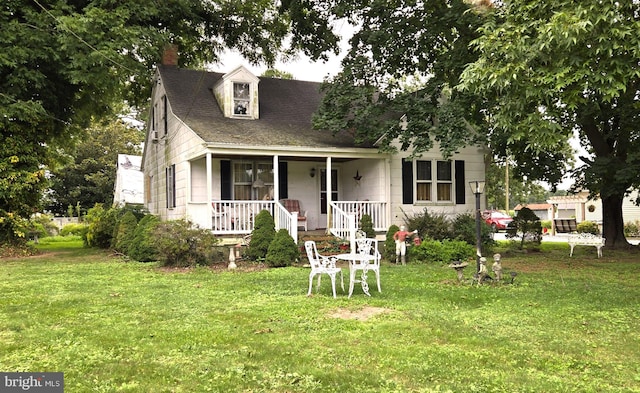 view of front of property with a front yard and covered porch