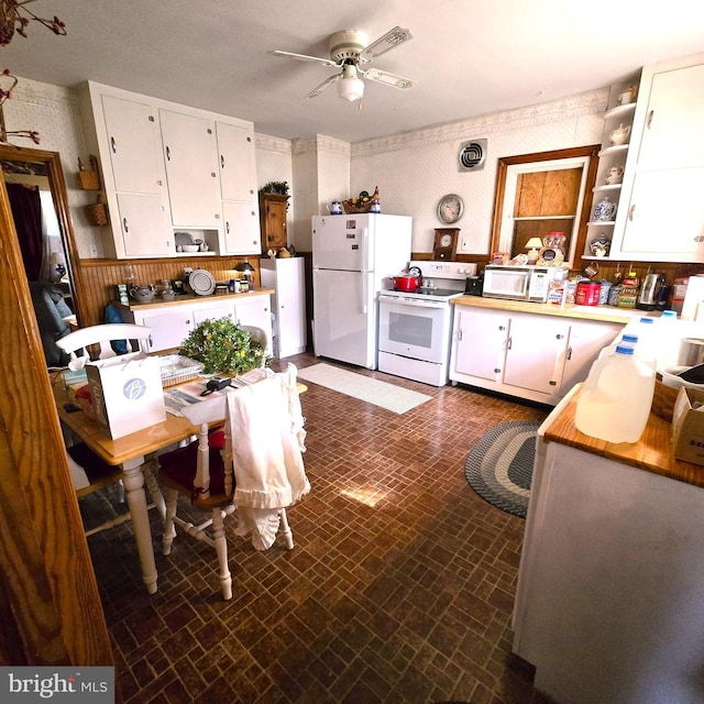 kitchen with ceiling fan, white appliances, and white cabinets