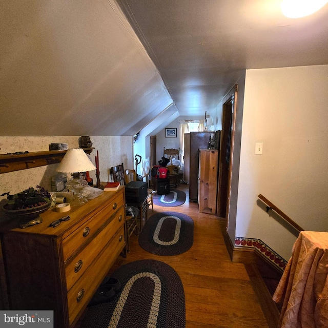 bedroom with vaulted ceiling and wood-type flooring