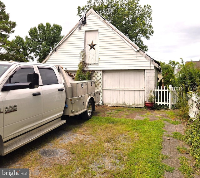 view of side of property featuring fence