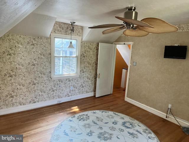 additional living space with ceiling fan and hardwood / wood-style flooring