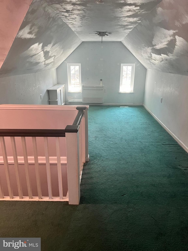 bonus room featuring a textured ceiling, carpet flooring, and vaulted ceiling