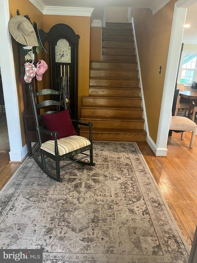 sitting room featuring hardwood / wood-style floors and crown molding