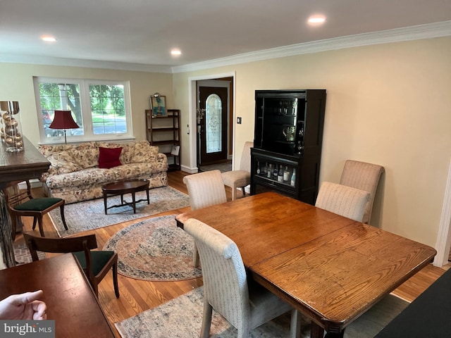 dining space featuring ornamental molding and hardwood / wood-style flooring