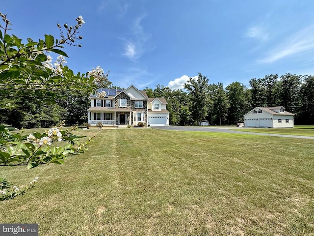 view of yard featuring a garage and covered porch