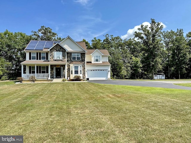 view of front of property featuring a front yard, solar panels, and covered porch