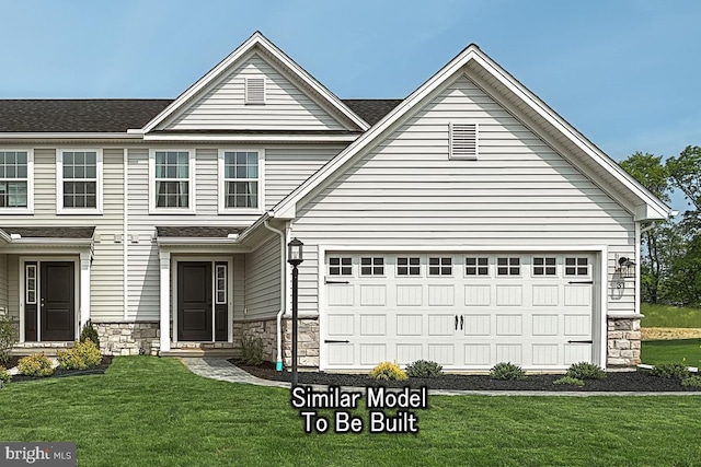 view of front of house with a garage and a front yard