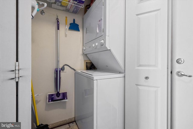 washroom featuring stacked washer and dryer