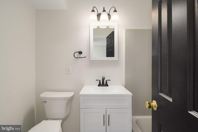 bathroom featuring toilet and vanity