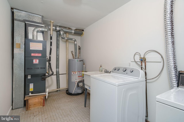 laundry area featuring water heater, light tile patterned floors, and heating unit