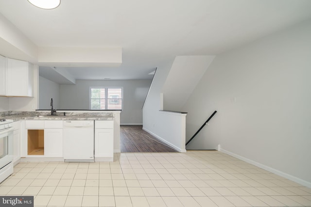 kitchen featuring light tile patterned flooring, sink, white dishwasher, and white cabinets