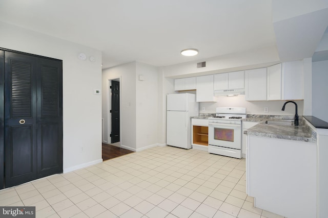 kitchen with white appliances, sink, light hardwood / wood-style floors, and white cabinetry