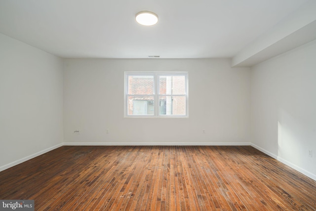 spare room with hardwood / wood-style flooring