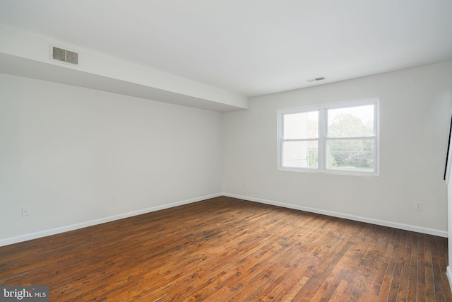 unfurnished room with wood-type flooring