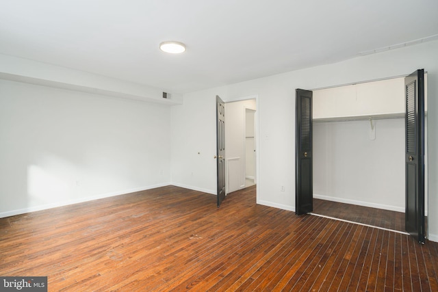 unfurnished bedroom featuring hardwood / wood-style flooring and a closet