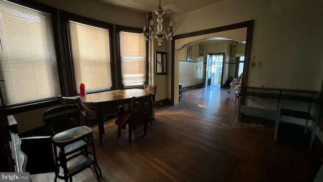 dining room featuring an inviting chandelier and dark hardwood / wood-style flooring