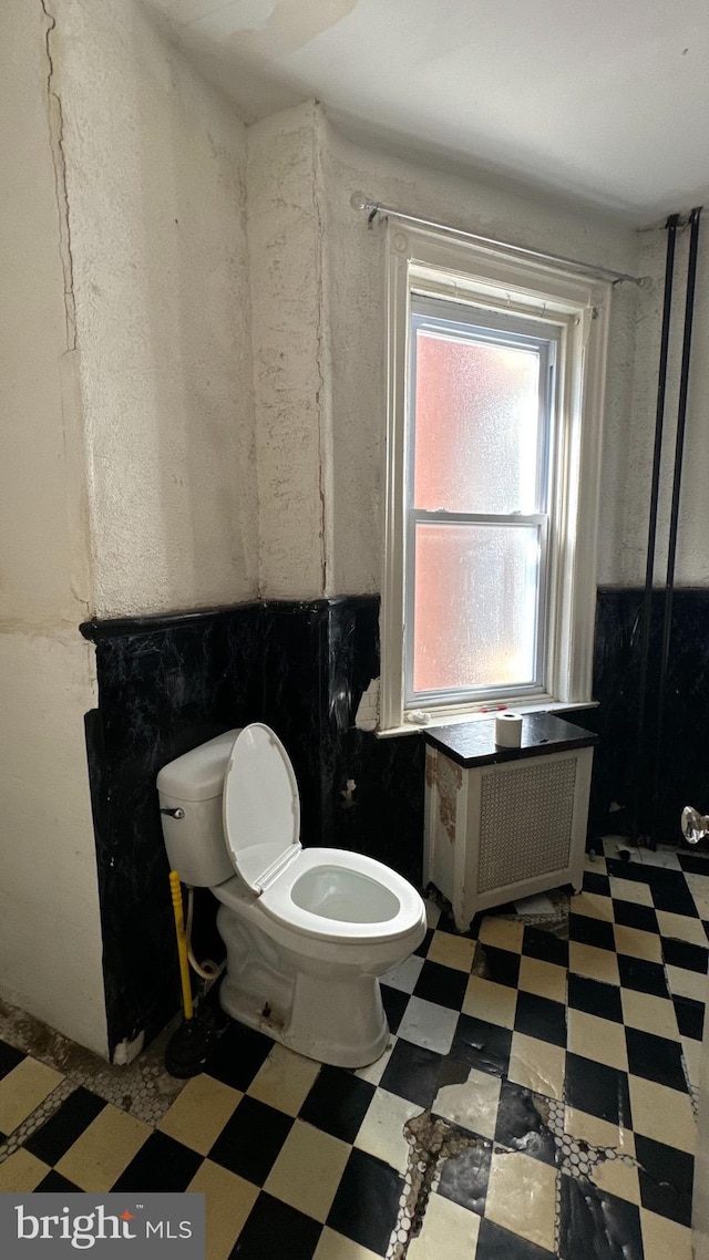 bathroom featuring toilet and radiator heating unit