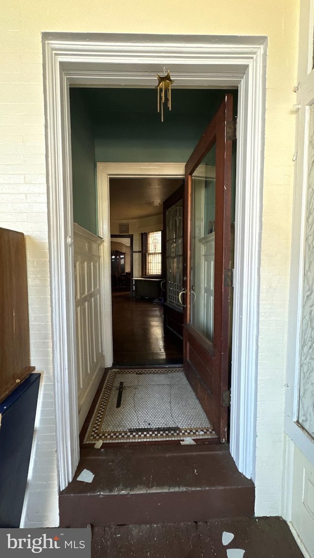 hallway with hardwood / wood-style flooring