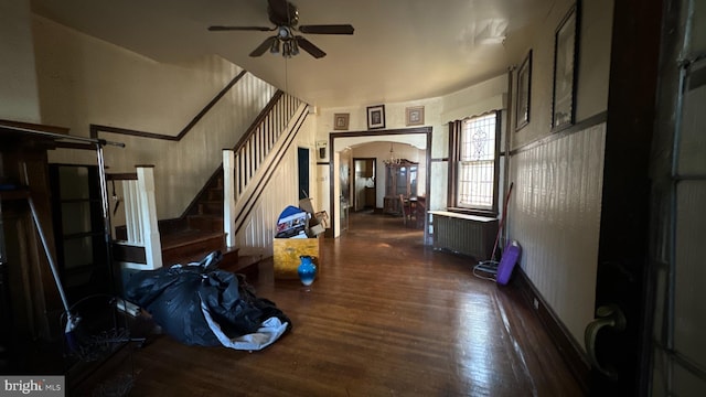 interior space featuring radiator, ceiling fan, and dark hardwood / wood-style flooring