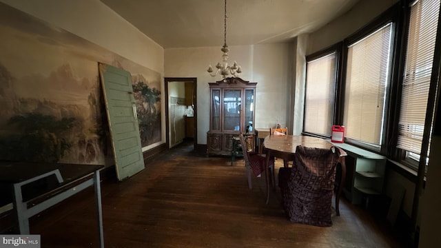 dining room with a notable chandelier and dark wood-type flooring