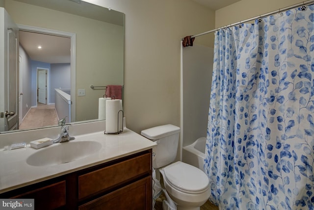 full bathroom featuring toilet, vanity, and shower / bathtub combination with curtain