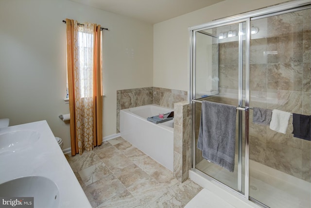 full bathroom with toilet, vanity, and separate shower and tub