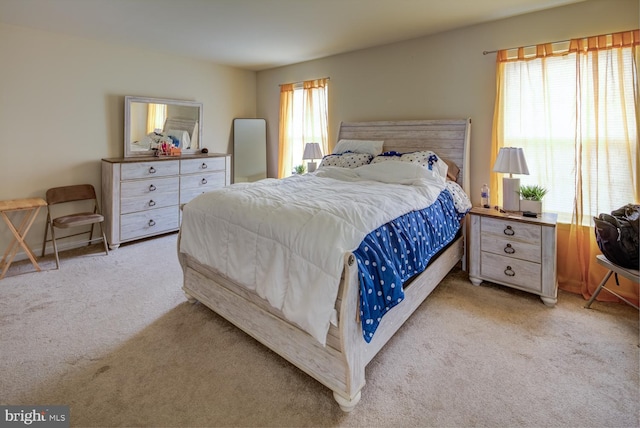 carpeted bedroom with multiple windows