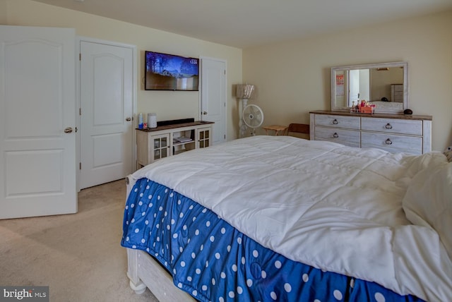 bedroom featuring light carpet