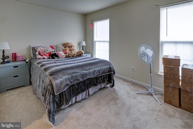 carpeted bedroom featuring multiple windows